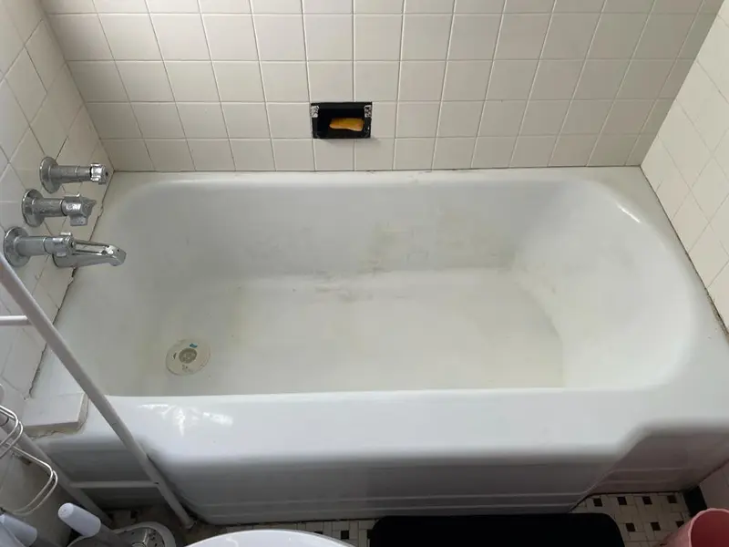 Clean white bathtub after move-out cleaning